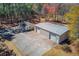 This aerial view showcases the buildings and surrounding lot and trees on the property at 692 W Union Grove Cir, Auburn, GA 30011
