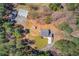 Aerial view of a house and barn surrounded by trees, and long driveway at 692 W Union Grove Cir, Auburn, GA 30011