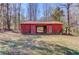 Rustic red barn with an open front and rear with access to the surrounding landscape at 692 W Union Grove Cir, Auburn, GA 30011