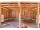 Inside view of barn featuring rustic wooden supports and bare earth floors at 692 W Union Grove Cir, Auburn, GA 30011
