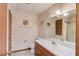 Bathroom featuring wood cabinets, a sink, toilet, and vanity at 692 W Union Grove Cir, Auburn, GA 30011