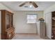 Bedroom with overhead fan, window, closet and vintage hutch at 692 W Union Grove Cir, Auburn, GA 30011