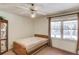 Neutral bedroom with a ceiling fan, carpet flooring, one window, and an accent cabinet at 692 W Union Grove Cir, Auburn, GA 30011