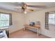 Bedroom with two windows, ceiling fan, desk, and neutral walls at 692 W Union Grove Cir, Auburn, GA 30011