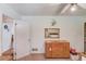 This bedroom has hardwood flooring, neutral-painted walls, and access to another room at 692 W Union Grove Cir, Auburn, GA 30011