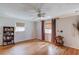 Spacious bedroom with hardwood floors, two windows, and a ceiling fan at 692 W Union Grove Cir, Auburn, GA 30011