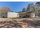 Exterior of the house and garage on the lot with beautiful trees at 692 W Union Grove Cir, Auburn, GA 30011