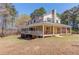 Exterior elevation of a beautiful home with a porch and lush green surroundings at 692 W Union Grove Cir, Auburn, GA 30011