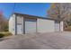 Exterior of the building showing three large garage doors with a door on the side at 692 W Union Grove Cir, Auburn, GA 30011