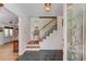 Warm foyer featuring slate floors, staircase with chairlift, and decorative glass front door at 692 W Union Grove Cir, Auburn, GA 30011
