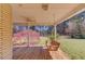 Cozy porch swing inviting relaxation on a charming covered front porch overlooking the yard at 692 W Union Grove Cir, Auburn, GA 30011