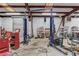 The interior of the garage is spacious with a car lift and plenty of storage at 692 W Union Grove Cir, Auburn, GA 30011