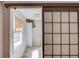 Hallway featuring a tiled floor, window, linen closet and shoji screen style sliding door at 692 W Union Grove Cir, Auburn, GA 30011