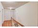 Upstairs hallway with hardwood flooring, white doors, and wood trim at 692 W Union Grove Cir, Auburn, GA 30011