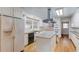 Bright kitchen with white cabinets, stainless steel appliances, an island, and a breakfast bar at 692 W Union Grove Cir, Auburn, GA 30011