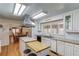 This spacious kitchen has white cabinets, stainless steel appliances, an island, and hardwood floors at 692 W Union Grove Cir, Auburn, GA 30011