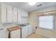 Laundry room with cabinets, sink, and updated washer and dryer at 692 W Union Grove Cir, Auburn, GA 30011