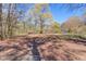 This shot shows the beautiful lot filled with trees at 692 W Union Grove Cir, Auburn, GA 30011