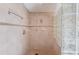 Shower with glass block wall, neutral tile, and grab bars at 692 W Union Grove Cir, Auburn, GA 30011