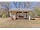 Covered exterior structure with lighting and a swing at 692 W Union Grove Cir, Auburn, GA 30011