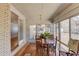 Sunroom featuring brick accent walls, hardwood flooring, and access to the backyard at 692 W Union Grove Cir, Auburn, GA 30011