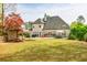 The backyard is a sprawling lawn, patio, and a home with large windows at 717 Robinson Farms Dr, Marietta, GA 30068