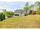 Spacious backyard with lush green lawn and mature trees offering privacy at 717 Robinson Farms Dr, Marietta, GA 30068