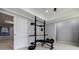 This is a finished basement gym with weightlifting rack, bench, and equipment, perfect for exercise at 717 Robinson Farms Dr, Marietta, GA 30068