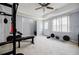 The carpeted basement gym features ceiling fan, natural light, and includes a weightlifting bench and workout equipment at 717 Robinson Farms Dr, Marietta, GA 30068