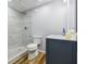 Modern bathroom featuring a gray tile shower, blue vanity, and wood-look floors at 717 Robinson Farms Dr, Marietta, GA 30068