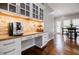 Coffee station with built-in cabinets, granite countertop, and stylish backsplash at 717 Robinson Farms Dr, Marietta, GA 30068