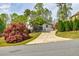 House showcasing a driveway with mature trees and landscaping, enhancing curb appeal at 717 Robinson Farms Dr, Marietta, GA 30068