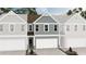 New construction townhome featuring blue siding, white trim, and a one-car garage at 6352 Towhee Way, Morrow, GA 30260