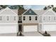 New construction townhome featuring a brick facade, blue accents, and a two-car garage at 6352 Towhee Way, Morrow, GA 30260