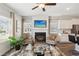 Bright living room featuring a fireplace, ceiling fan, and sleek furnishings at 6352 Towhee Way, Morrow, GA 30260