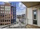 Balcony view with glass railing overlooking a city neighborhood with Georgia Tech building at 1100 Howell Mill Nw Rd # 408, Atlanta, GA 30318