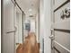 Hallway with hardwood floors, sliding barn door, and unit number at 1100 Howell Mill Nw Rd # 408, Atlanta, GA 30318