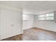 Basement area with wood-look floors, windows, and a double-door closet at 120 Maryeanna Ne Dr, Atlanta, GA 30342