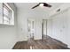 Bedroom includes wood-look flooring, ceiling fan, closet with mirrored doors, and access to a bathroom at 120 Maryeanna Ne Dr, Atlanta, GA 30342