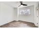 Clean bedroom with wood-look flooring, a ceiling fan, and a bright window at 120 Maryeanna Ne Dr, Atlanta, GA 30342