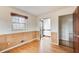 Bedroom with hardwood floors, natural wood-paneled walls, and multiple windows at 120 Maryeanna Ne Dr, Atlanta, GA 30342