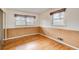 Cozy bedroom with hardwood floors, natural wood-paneled walls, and window at 120 Maryeanna Ne Dr, Atlanta, GA 30342