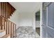 Inviting foyer featuring stone tile flooring, wainscoting, and a staircase with wooden railing at 120 Maryeanna Ne Dr, Atlanta, GA 30342
