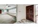 Foyer leading into a bright multi-window sunroom featuring ceiling fans and carpeting at 120 Maryeanna Ne Dr, Atlanta, GA 30342