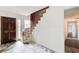 Bright foyer featuring tile flooring, a dark wood front door, and a staircase at 120 Maryeanna Ne Dr, Atlanta, GA 30342