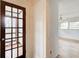 Hallway featuring a hardwood door leading to a bright bedroom with multiple windows at 120 Maryeanna Ne Dr, Atlanta, GA 30342