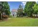 Spacious backyard with lush green lawn, mature trees, and patio, perfect for outdoor entertaining at 1239 Bonshaw Trl, Marietta, GA 30064