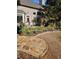 Secluded backyard with stone pavers and vibrant yellow daffodils at 1239 Bonshaw Trl, Marietta, GA 30064