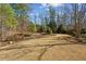 Expansive backyard with a stone border and wooded area, providing privacy and natural beauty at 1239 Bonshaw Trl, Marietta, GA 30064
