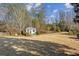 Backyard featuring a green grass area and a white gazebo surrounded by trees at 1239 Bonshaw Trl, Marietta, GA 30064